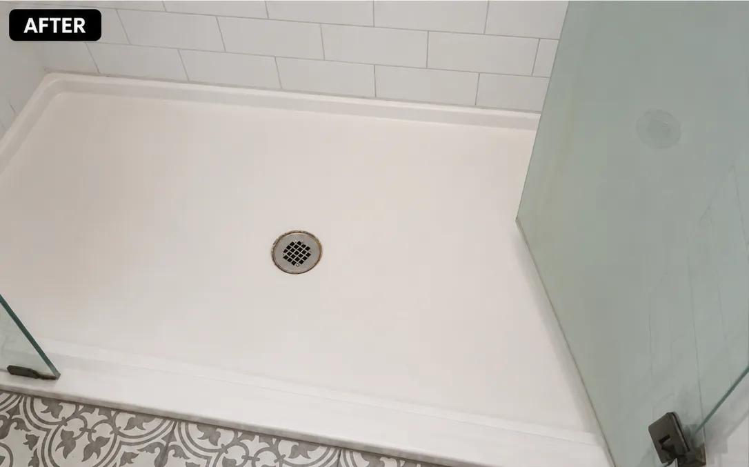 Renovated shower space featuring a clean base, glass door, and patterned tile.