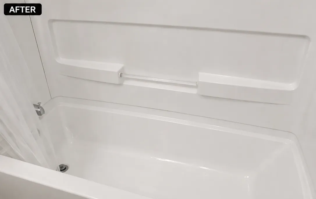 Renovated bathtub interior with clean white surfaces and minimalistic design.