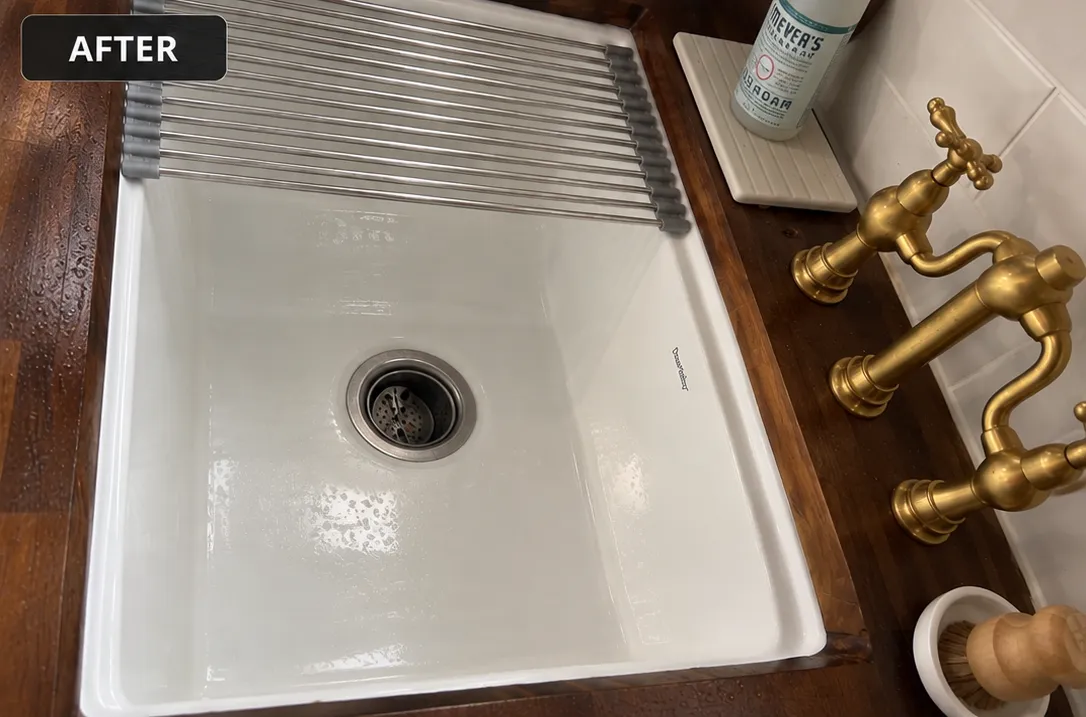 Updated modern kitchen sink with gold faucets and a clean, stylish design.