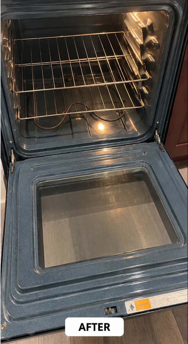 Clean oven interior with shiny racks and glass door, showing spotless condition after cleaning.