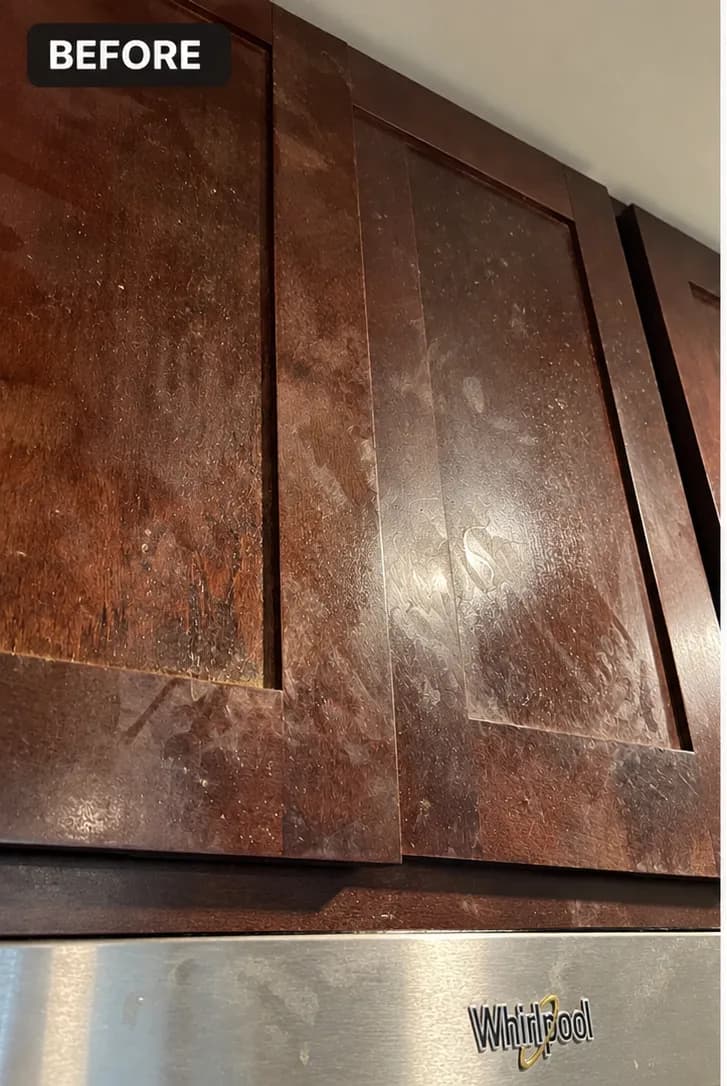 Dull kitchen cabinets before cleaning, showing visible grime and scratches.